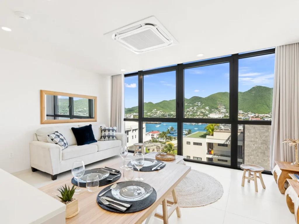 Modern living room with white sofa and tropical landscape view